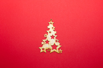 Naklejka na ściany i meble Christmas wooden toy Christmas tree on a red background