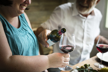Man pouring red wine into a glass