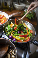 Japanese woman cooking stir fried vegetables