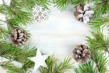 Christmas background with fir tree branches, cones, snow, xmas decorations and copy space