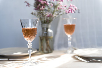 Two glasses of champagne on a dining table