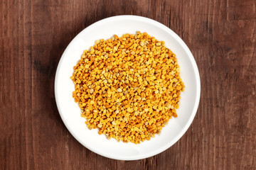 Healthy organic food. An overhead photo of pollen, shot from above on a dark rustic background with copy space