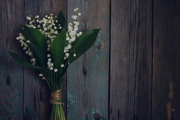Lily of the Valley on old wooden background