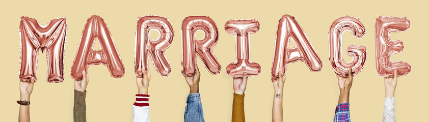 Pink alphabet balloons forming the word marriage