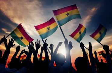 Silhouettes of People Holding Flag of Ghana