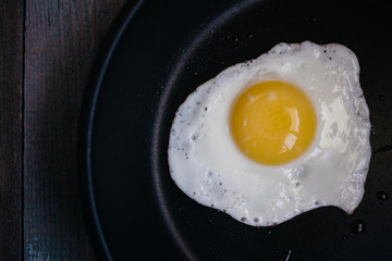 fried eggs in a frying pan on a wooden table, Breakfast, top view