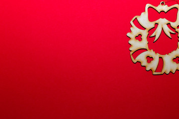 Christmas wooden toy christmas wreath on a red background