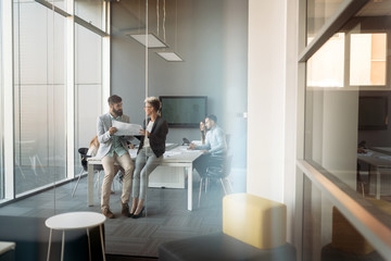 Group of coworkers working together on business project in modern office