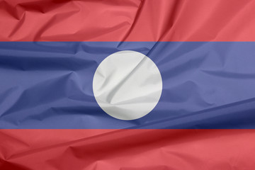 Fabric flag of Laos. Crease of Lao flag background, blue red and white circle color.