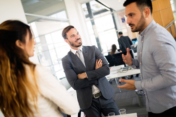 Group of coworkers working together on business project in modern office