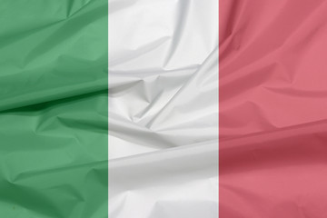 Fabric flag of Italy. Crease of Italian flag background, green white and red color.
