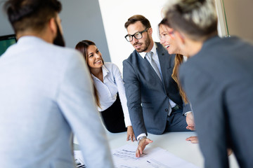 Group of coworkers working together on business project in modern office