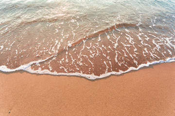 Sandy beach with waves on it. Background with place for text.