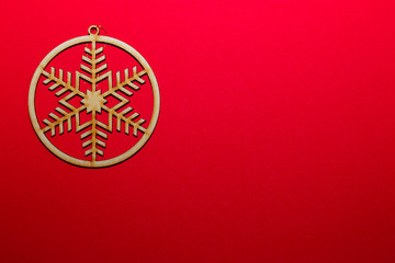 Christmas wooden toy snowflake on a red background