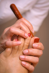 Massage therapist massaging legs of pregnant woman