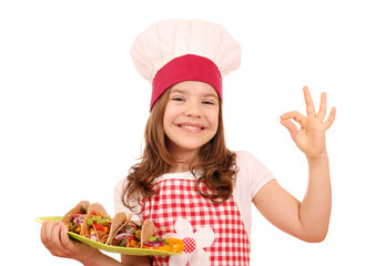 little girl cook with tacos and ok hand sign