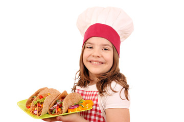 little girl cook with tacos on plate