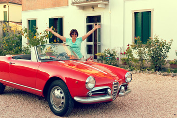 Montagnana, Italy August 27, 2018: Girl driving Retro car convertible 1961 ode release.