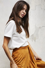 Fototapeta premium Gorgeous posing brunette in white and orange, portrait