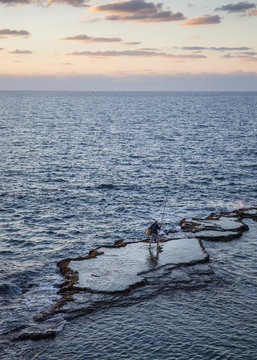 Fisherman at the sea, Acre (Akko), Israel.