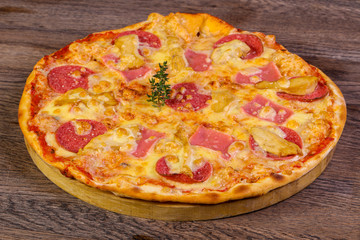 Pizza with ham and sausages