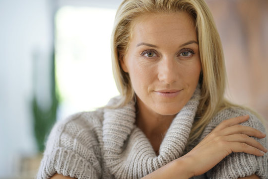 Portrait of 40-year-old woman with woolen sweater