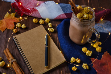 Naklejka na ściany i meble cocoa with popcorn and cinnamon on a slate background with lights
