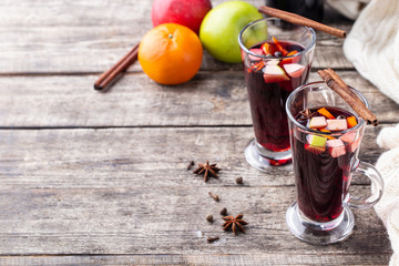 Hot drink. Mulled wine with apples, oranges and spices.
