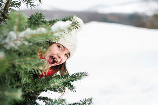 A small girl having fun in snow.