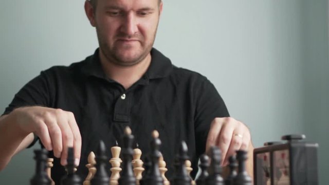 A man plays chess. He plays white