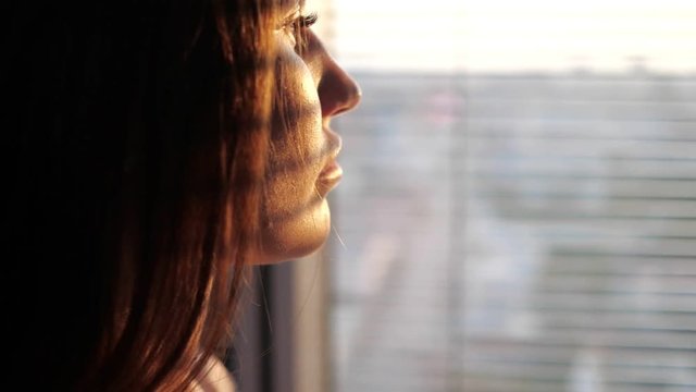 close up of a girl looking out the window