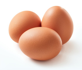 three raw chicken eggs isolated on white background