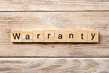 warranty word written on wood block. warranty text on table, concept