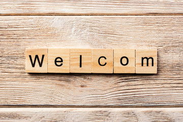 welcom word written on wood block. welcom text on table, concept