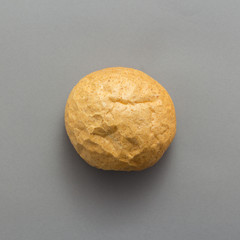 Freshly baked bread on grey background, top view