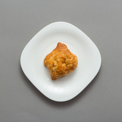 Freshly baked butter croissant grey background, top view
