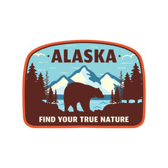 Alaska badge design. Mountain adventure patch. American travel logo. Cute retro style. Find your true nature custom quote. Bear walking through the forest. Stock vector emblem