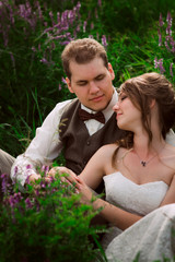 bride and groom portrait on the background of a mountain and grass
