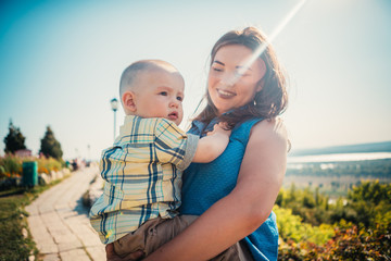 happy mother and toddler son on nature background