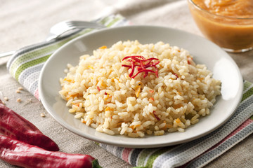Spicy parboiled rice with carrots, yellow zucchini and chili peppers