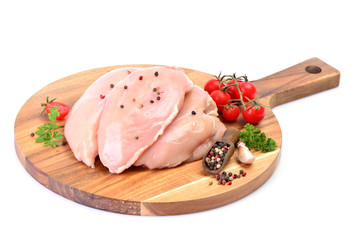 Chicken meat with spices and vegetables on a white background