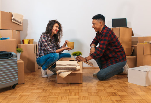 Happy young couple moving into their new home.
