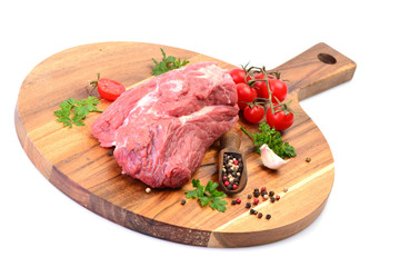 Beef meat with spices and vegetables on a white background