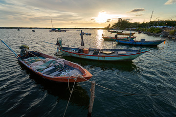 Fototapeta premium View of the fishing harbor Sunset Latinos There is a boat landing. In a fishing village in Rayong, Thailand, fishing is the main occupation of the people.