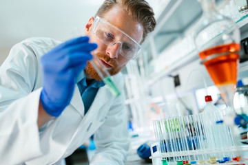 Handsome student of chemistry working with chemicals