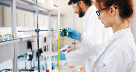 Attractive student of chemistry working in laboratory
