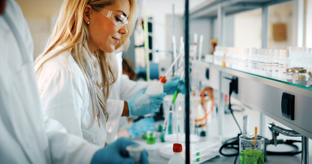 Young students of chemistry working in laboratory