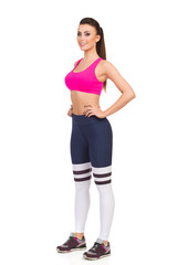 Beautiful Young Woman In Pink Sports Bra And Leggings. Front Side View.