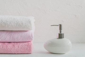 clean and soft towels and soap on white background