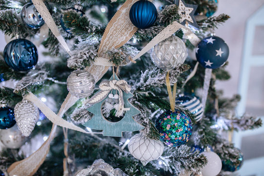 Christmas blue and white decorations on the Christmas tree, snowflakes balls garlands, closeup texture background